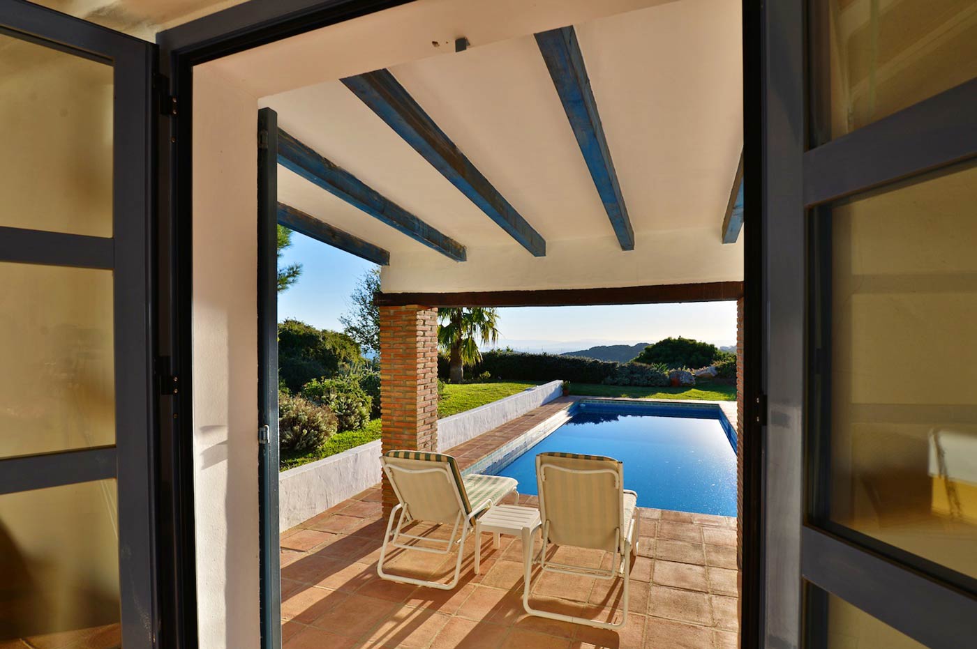Bedroom 1 has direct access to a covered terrace and the pool