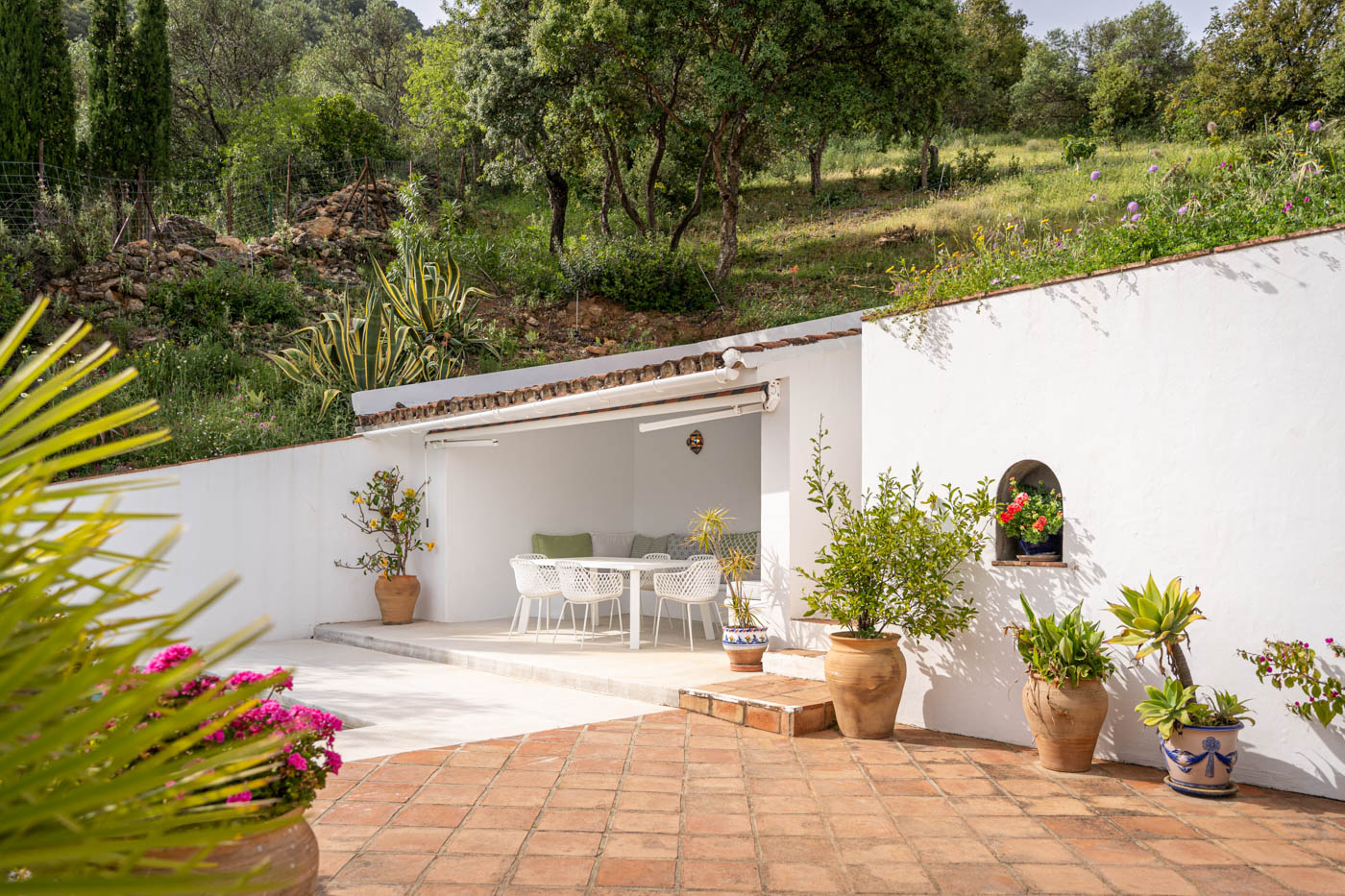Outdoor dining area with awning next to the pool