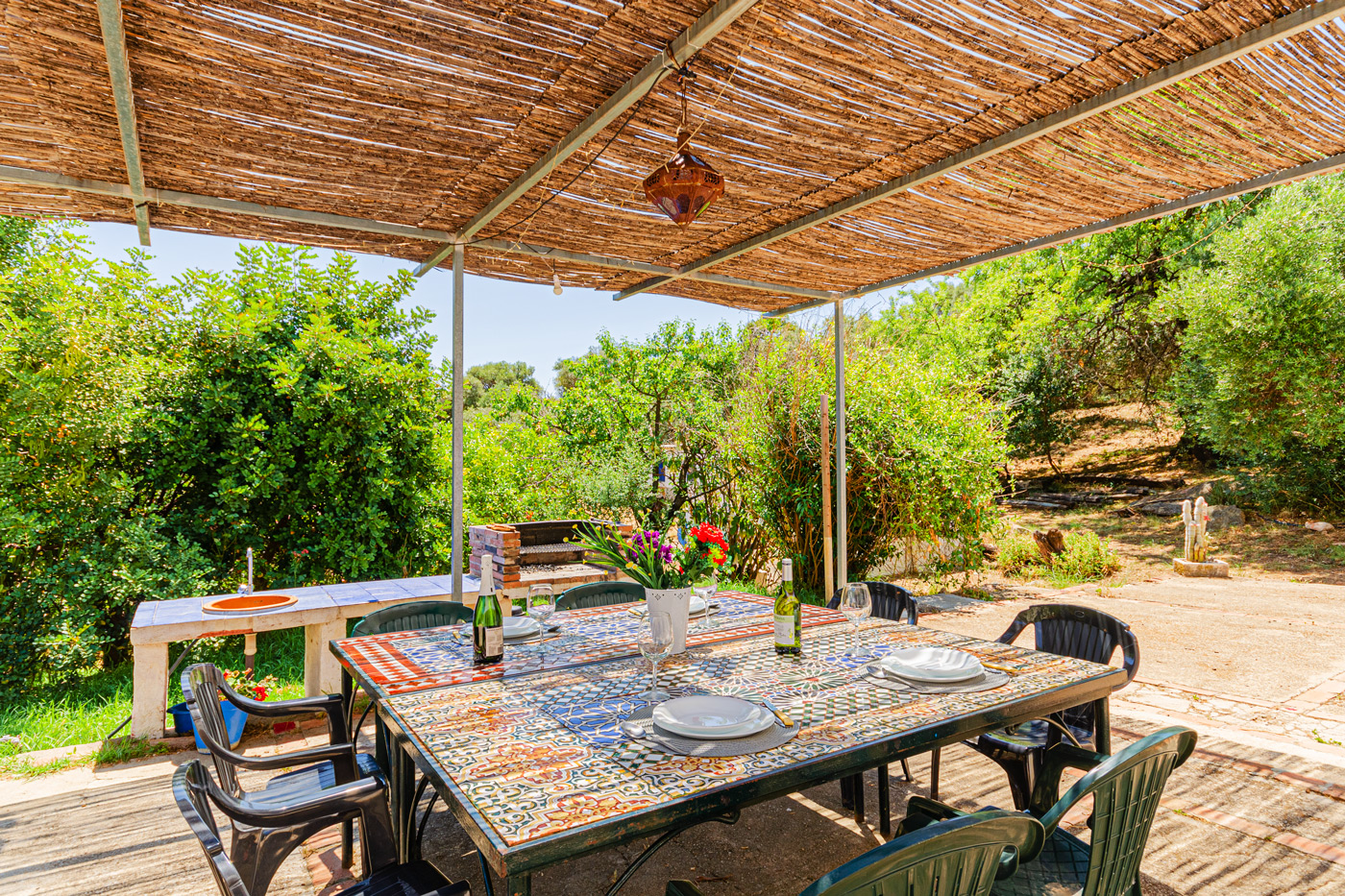 Barbecue area and outdoor seating area next to kitchen