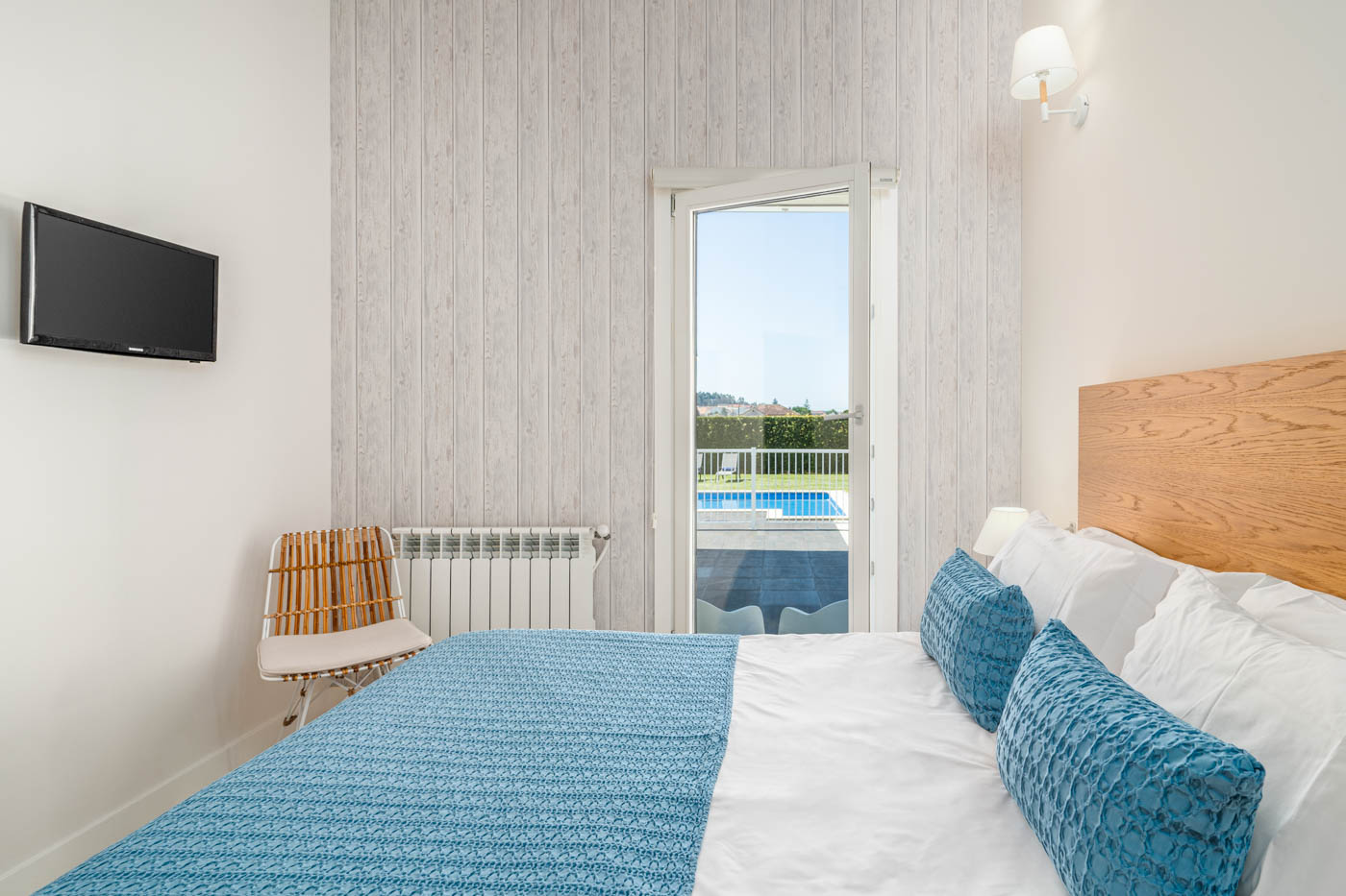 Bedroom with window looking onto pool area