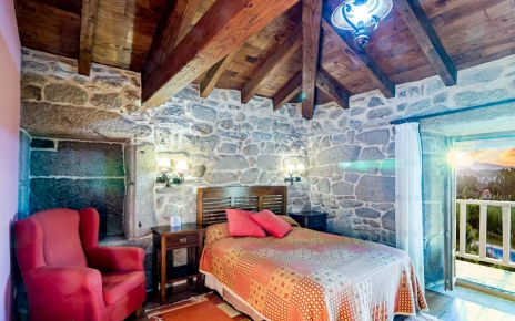 Habitación con cama doble y balcón.