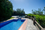 Pool and villa seen from shaded area