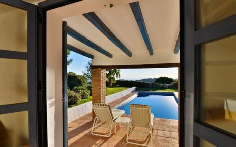 Bedroom 1 has direct access to a covered terrace and the pool