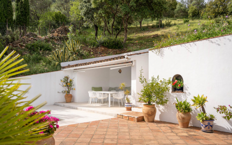 Outdoor dining area with awning next to the pool