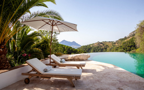 Sunloungers and parasols by the pool