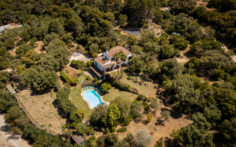 Parking area, villa and gardens seen from the sky
