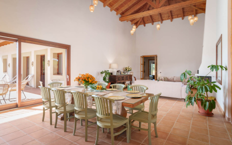 Indoor dining area with doors to furnished terrace