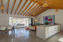 Kitchen with ample glass panels opening to terrace
